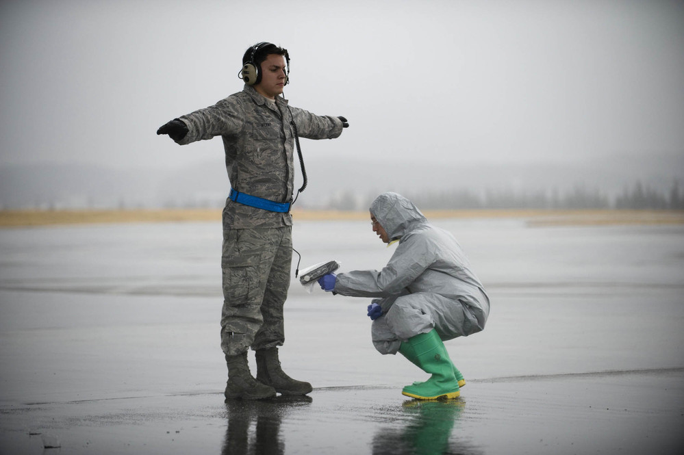 Personnel and environment being scanned with handheld instruments for radioactive contamination 
